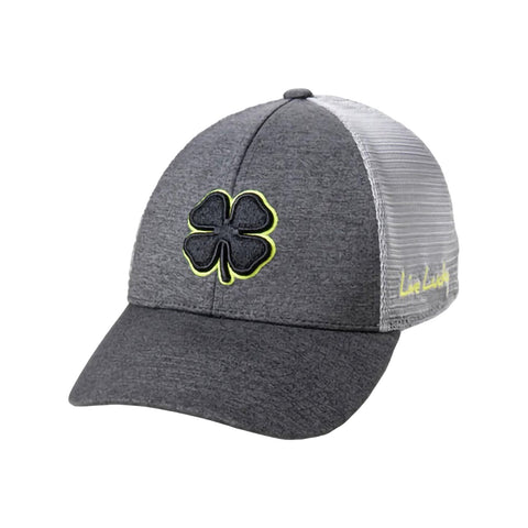 A gray baseball cap features a black four-leaf clover emblem and a yellow outline on the front while the side displays the text Live Lucky in yellow along a mesh panel.