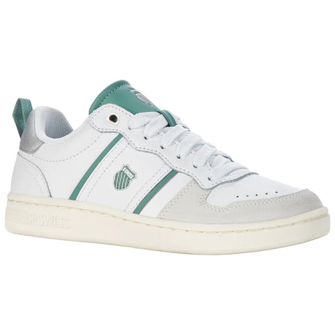 A white sneaker with green accents has a rounded toe and a low-top design featuring laces and a logo on the side set against a plain white background.