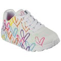 A white sneaker is decorated with colorful heart designs in various shades including pink blue yellow and purple featuring white laces and a textured sole suitable for casual wear