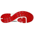 A gray athletic shoe sole features a red rubber surface with various traction spikes and grooves designed for grip on different surfaces providing stability during physical activities.