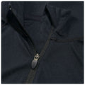 A black zippered garment features a close-up view of its collar and zipper detailing showcasing a durable fabric and stitching design against a soft textured background.