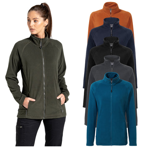 A woman is wearing a dark green zip-up fleece jacket with her hands in the pockets surrounded by several other fleece jackets in different colors including orange black navy and teal