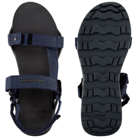 A pair of navy sandals is shown with fabric straps and a textured black sole positioned flat. They are designed for comfort and durability in outdoor settings.