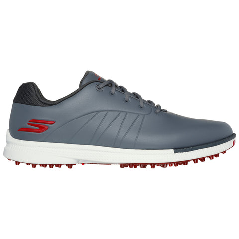 A gray athletic shoe with a smooth finish features red accents and a spike outsole designed for traction on grass surfaces while positioned against a white background.