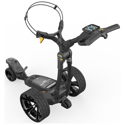 A black golf push cart features a handle with control buttons and a digital display for tracking performance it has large wheels for mobility in outdoor environments.