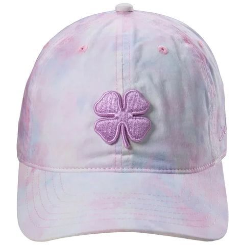 A pastel tie-dye cap featuring a prominent purple four-leaf clover emblem on the front is displayed against a neutral background emphasizing its design and color scheme.