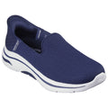 A navy slip-on shoe is positioned at an angle showing its textured upper mesh and white sole designed for comfort and mobility in casual settings.