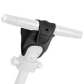 A black handlebar grip cover is positioned on a white scooter handlebar providing cushioning and increased grip while enhancing comfort for the rider in an urban environment.