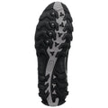 Black shoe sole with aggressive traction pattern lies on a flat surface showcasing deep grooves and spikes designed for grip during outdoor activities or running in uneven terrain.