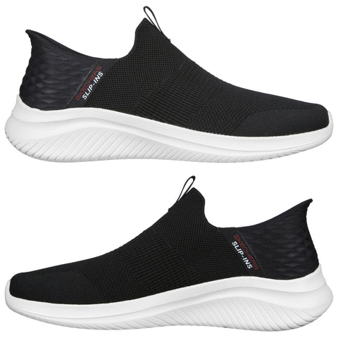 A pair of black slip-on shoes featuring a textured upper and a white sole with ridges sits against a neutral background showcasing their sleek and modern design.