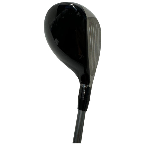 A golf club head designed for driving sits at an angle showcasing its sleek black surface and textured striking face with grooves while the grip is connected to a long shaft.