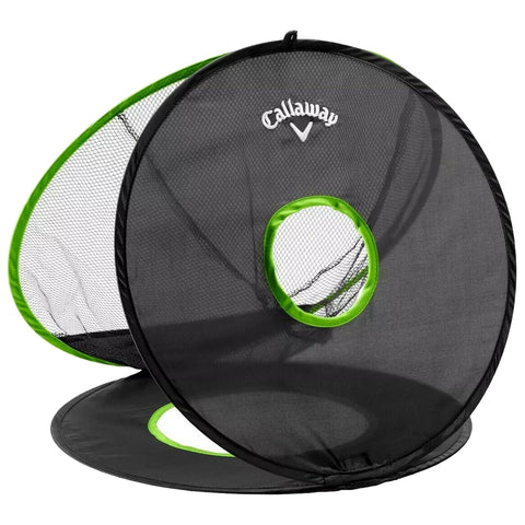 A black and green collapsible golf chipping net stands upright with two circular net openings designed for practicing golf shots in an outdoor setting.