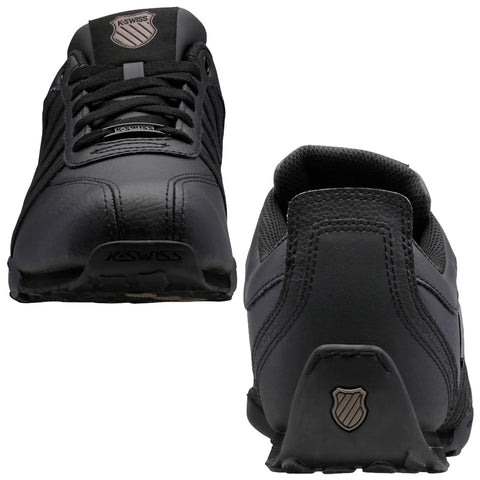 Black athletic shoes are displayed from the front and back views showcasing a sleek design made of leather and mesh with prominent laces and a logo on the tongue and heel