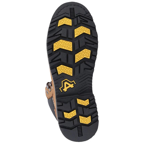 A brown and black shoe sole with a tread pattern featuring yellow accents is positioned vertically showcasing grip and stability designed for outdoor or rugged use on uneven terrain.