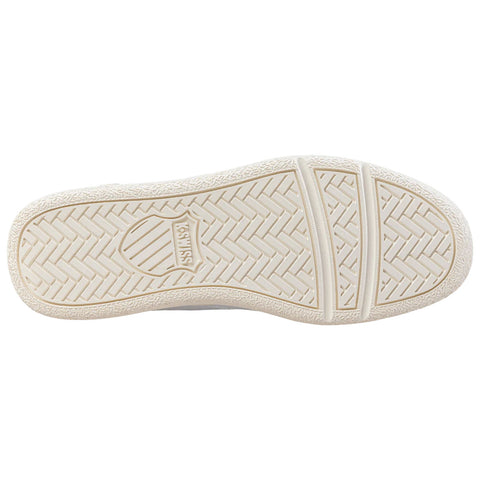 A sneaker sole is displayed prominently showing a textured rubber pattern with a logo in the center indicating brand name the background is plain and unobtrusive.