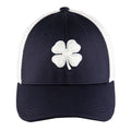 A dark navy cap features a white embroidered four-leaf clover on the front with a solid fabric panel and mesh sides designed for casual outdoor wear and sun protection.