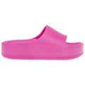 A pink slide sandal is displayed sideways showcasing its open-top design and thick sole. The smooth surface indicates a casual footwear item suitable for warm weather or indoor use.