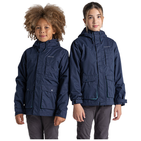 Two children wear similar navy blue jackets with hoods standing side by side. They are smiling at the viewer in a neutral background, showcasing the jackets' design.