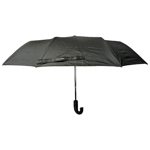 A black umbrella is opened upwards with a curved handle hanging downward in a neutral background suggesting outdoor use against rain or sun. The brand name EYELIEVE is visible on the fabric.