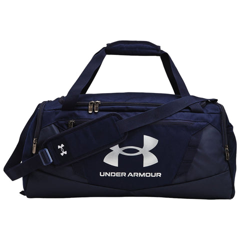 A dark blue duffel bag features a prominent white Under Armour logo on the side with two carrying handles and an adjustable shoulder strap sitting on a flat surface.