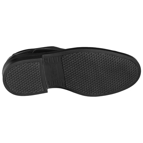 Black shoe sole with a textured surface for grip placed on a flat surface showcasing a simple and functional design intended for durability and traction during movement.