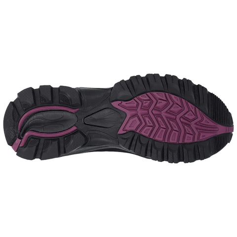 A shoe sole displays a rugged black and purple design featuring deep grooves and patterns for traction designed for outdoor activities on varied terrain.