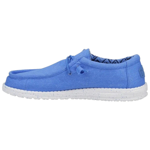 A blue slip-on shoe features a textured upper with a lacing system and a white speckled sole suitable for casual wear in everyday environments.