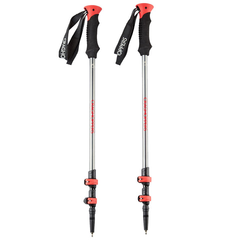 Two hiking poles are positioned upright with rubber grips and adjustable metal shafts showing red accents. They are designed for stability and support during outdoor activities like trekking or hiking.