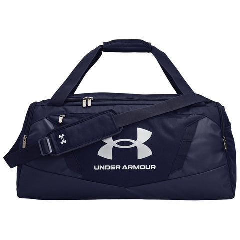 A dark navy duffel bag is displayed with a prominent white Under Armour logo on the side featuring dual handles and an adjustable shoulder strap positioned on a plain background.