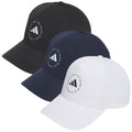 Three baseball caps are displayed in a row. The black and navy caps are on the left and center, while a white cap is on the right. Each features a circular logo with text.