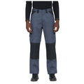 Work pants are being worn by a person standing upright with arms at their sides in a neutral stance the pants are dark grey with black detailing and pockets suitable for work environments