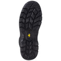 A black shoe sole features deep tread patterns designed for traction and stability showcasing a prominent logo with a yellow accent centered on the sole's design.