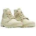 Beige high-top sneakers are positioned upright with laces tied showcasing a rubber sole and textured details against a plain white background