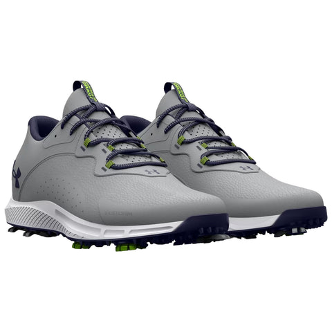 Gray golf shoes display intricate design features like textured surface and spike outsole positioned side by side on a plain background highlighting their athletic purpose and modern aesthetics.