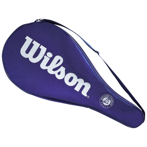 A tennis racket cover is positioned at an angle featuring a large white Wilson logo The cover is purple and has a shoulder strap and a Roland Garros emblem