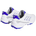 A pair of white athletic shoes with blue accents sits side by side featuring a textured sole for traction and three distinct stripes on each side ideal for sports activities.