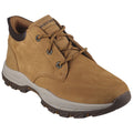 A tan hiking shoe sits prominently featuring a smooth leather upper with metal eyelets and thick rubber sole designed for traction while being placed against a neutral background.