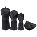 Three golf club head covers in black leather with white stitching displaying numbers and symbols are arranged alongside a matching small pouch in a neutral setting.