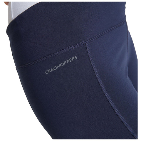 Navy leggings are prominently displayed showcasing a fitted design and a visible logo on the waistband with a textured fabric against a neutral background.