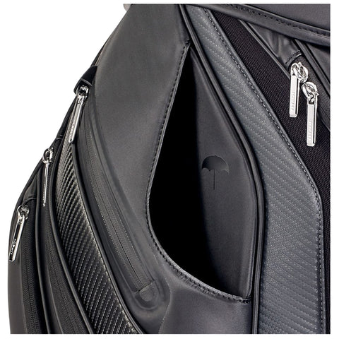 A sleek black backpack features several zippered compartments revealing a smooth interior with a subtle umbrella logo embossed on the fabric highlighting a stylish and functional design.