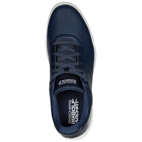 A navy blue sneaker with a smooth surface features a lace-up design and a padded collar showcasing the brand logo on the insole set against a plain background.