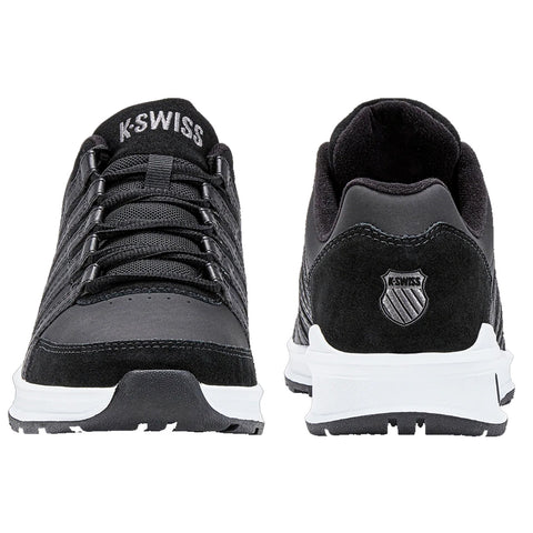 Black athletic shoes with a smooth surface and laces are displayed side by side showing a logo on the heel and a cushioned sole suitable for sports or casual wear.