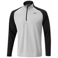 A long-sleeved athletic shirt features a grey body with black sleeves and a zippered collar designed for comfort and performance in active sports settings.