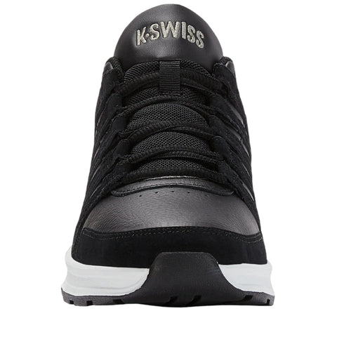 A black athletic shoe stands upright showcasing its sleek design and laces while being set against a plain background highlighting its details and brand logo on the tongue