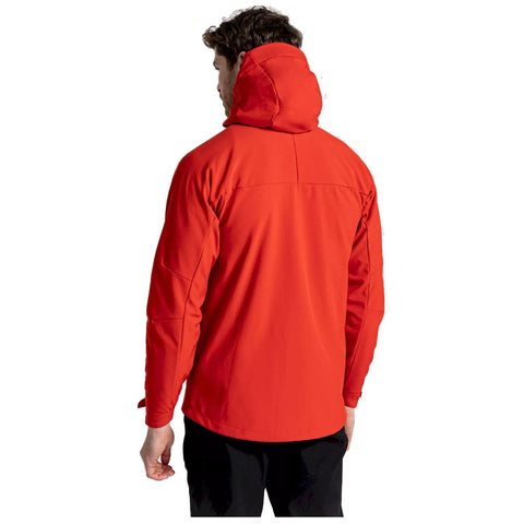 A person wearing a bright red jacket with a hood stands facing away in a blank background, emphasizing the garment's color and design without any other context or details.