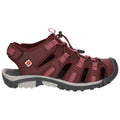 A sandal with a maroon and pink color scheme features an open design and adjustable straps it is positioned against a neutral background suggesting a casual outdoor environment.