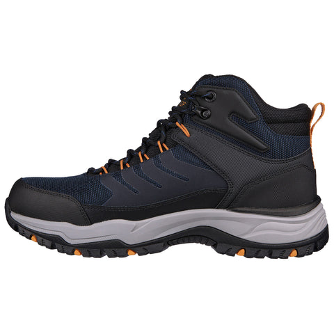 A hiking boot with a dark blue and black color scheme features orange accents laces and a sturdy sole designed for traction on rugged terrain.