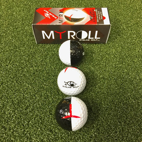 Three golf balls arranged on artificial grass. The top ball is black and white split vertically while the two below are white with black and red designs. A MY ROLL box is in the background.