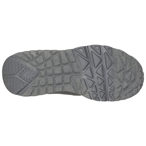 A gray shoe sole displays a textured surface with various patterns designed for traction the context suggests a focus on outdoor or athletic use.