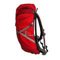 A red backpack stands upright featuring adjustable straps and multiple compartments showcasing a sleek design suitable for outdoor activities in a versatile environment like hiking or travel.